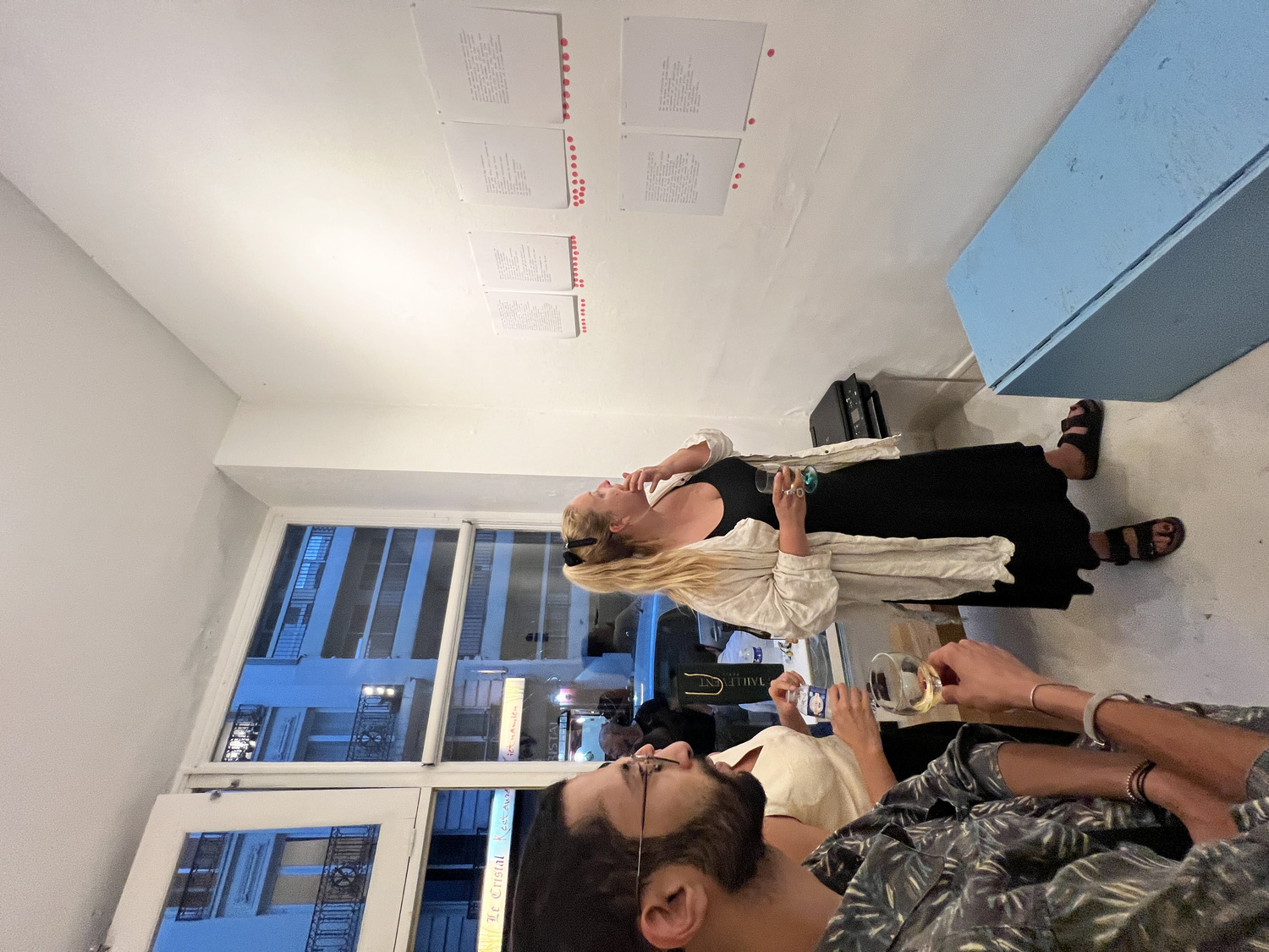 Audience member placing a carnation vote on their preferred poem