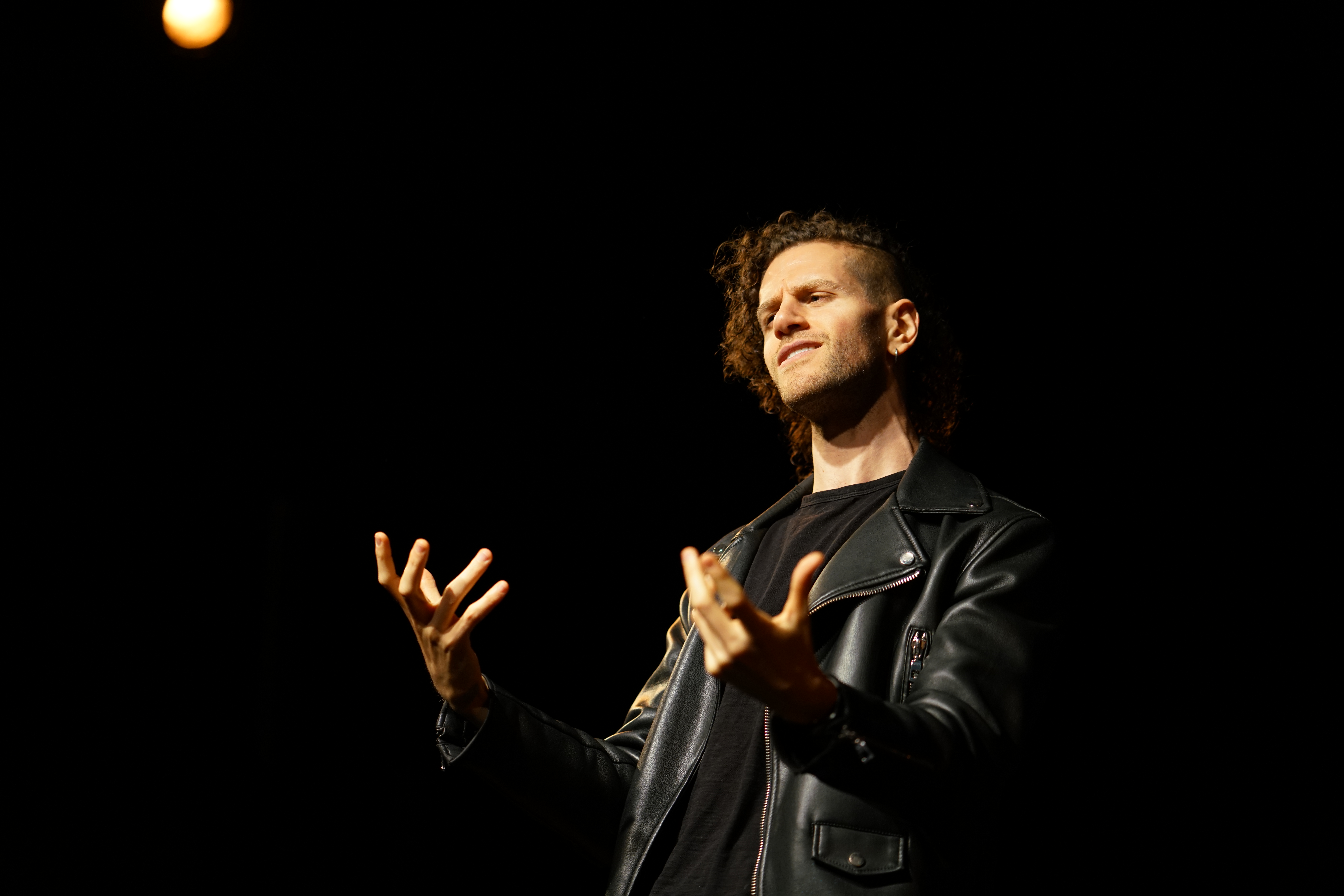 Invasions performance — the poet reading and replying live to scam texts on stage