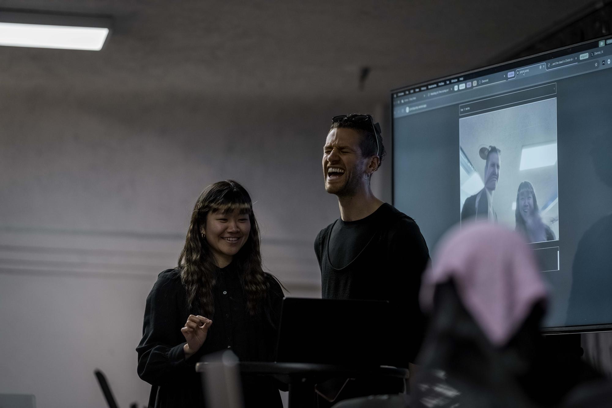 Halim Madi and a participant laughing at a live web demo during a workshop