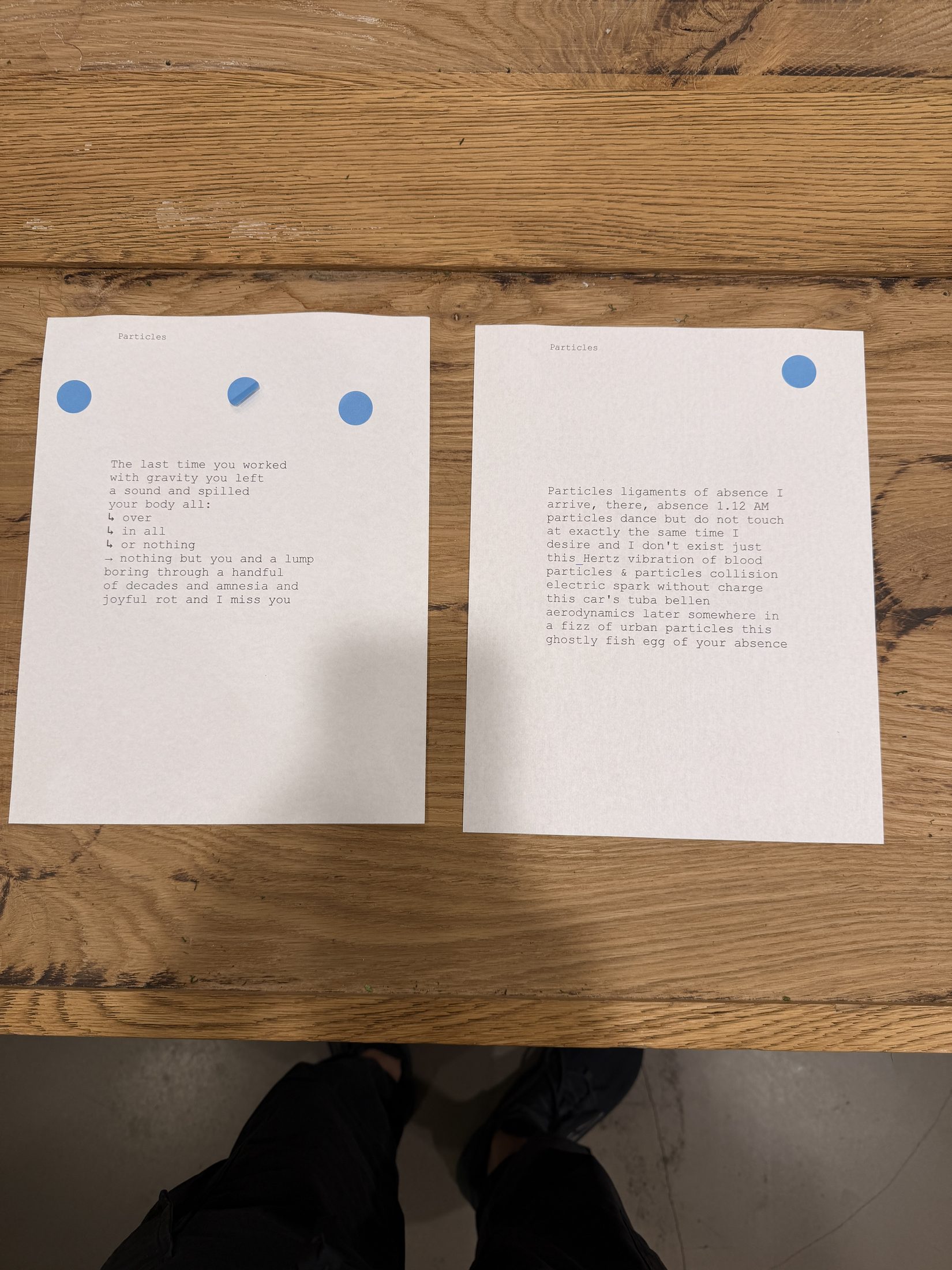 Two printed poems side by side with blue voting stickers
