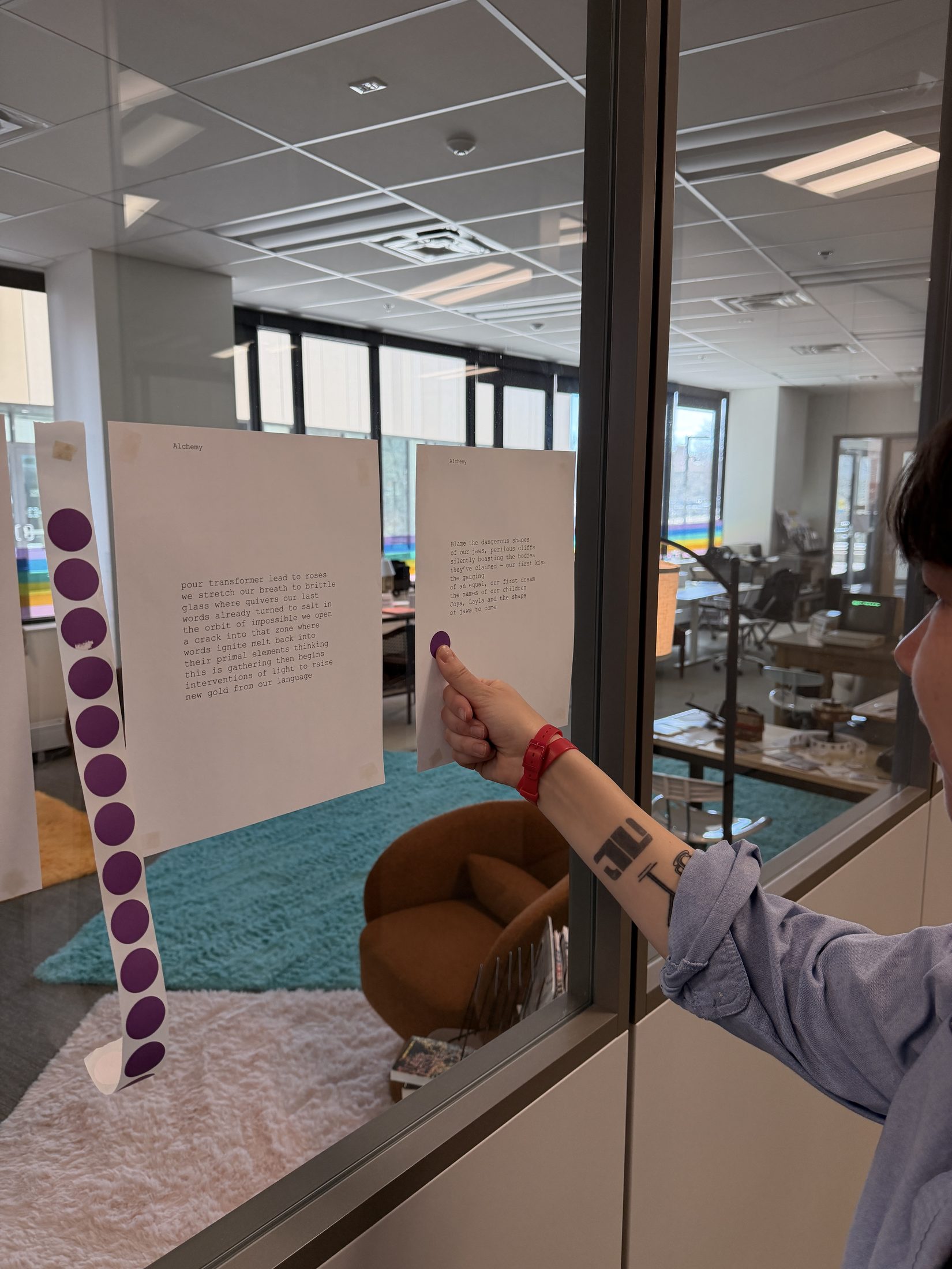 Printed poems with purple voting stickers at the Media Archaeology Lab