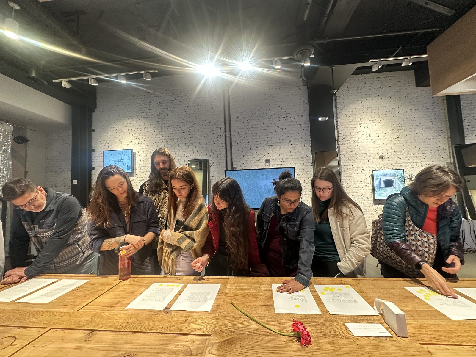 Audience engaging with printed poems